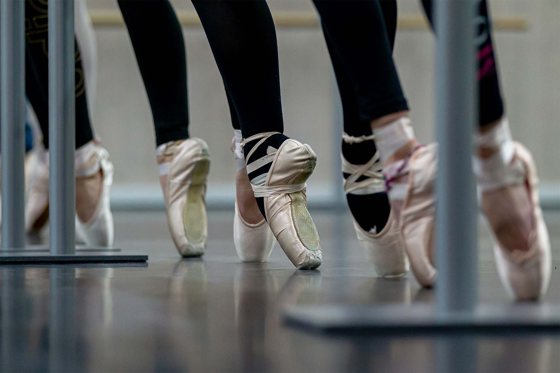 Young dancers relaxing between rehearsals during competition season, highlighting behind the scenes dance content and studio storytelling.